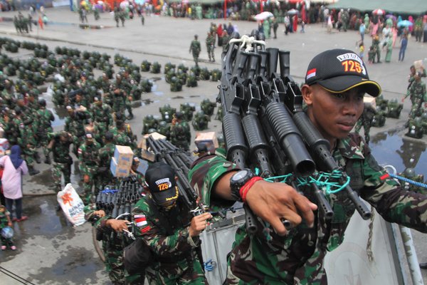 Sejumlah prajurit mengangkat senjata ke atas KRI Teluk Parigi 539 usai Upacara Pemberangkatan Satgas Pamtas RI-PNG Sektor Utara Batalyon Infanteri 725 Woroagi di Pelabuhan Kendari, Kendari, Sulawesi Tenggara, Kamis (8/11/2018). Sebanyak 450 orang prajurit TNI Angkatan Darat dari Batalyon Infanteri 725 Woroagi diberangkatkan pengamanan ke Perbatasan RI-Papua Nugini selama 10 bulan. - Antara