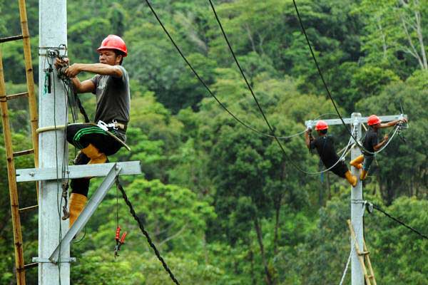 Pekerja memasang instalasi listrik di desa Kamiri, Barru, Sulawesi Selatan, Senin (15/1). - ANTARA/Yusran Uccang