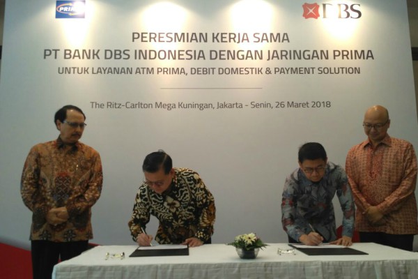 Wawan Salum, Head of Consumer Banking Group PT Bank DBS Indonesia (kedua dari kanan) dan Suryono Hidayat, Direktur Marketing PT Rintis Sejahtera (kedua dari kiri) menandatangani perjanjian kerja sama di Hotel Ritz Carlton Kuningan, Jakarta, Senin (26/3/2018). (Bisnis - Abdul Rahman) 