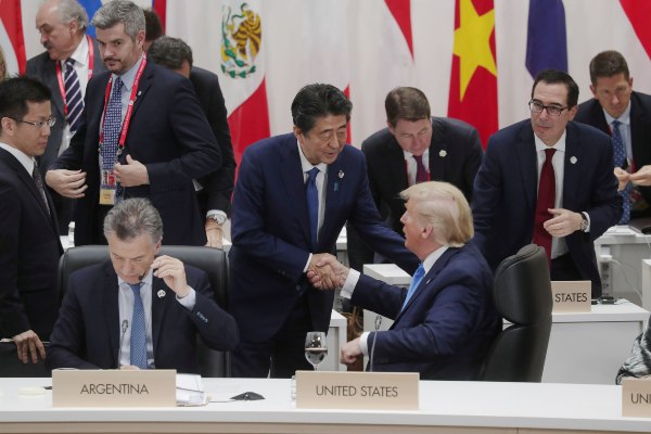 Perdana Menteri (PM) Jepang Shinzo Abe berjabat tangan dengan Presiden AS Donald Trump di KTT G20 di Osaka, Jepang, Sabtu (29/6/2019). - Reuters