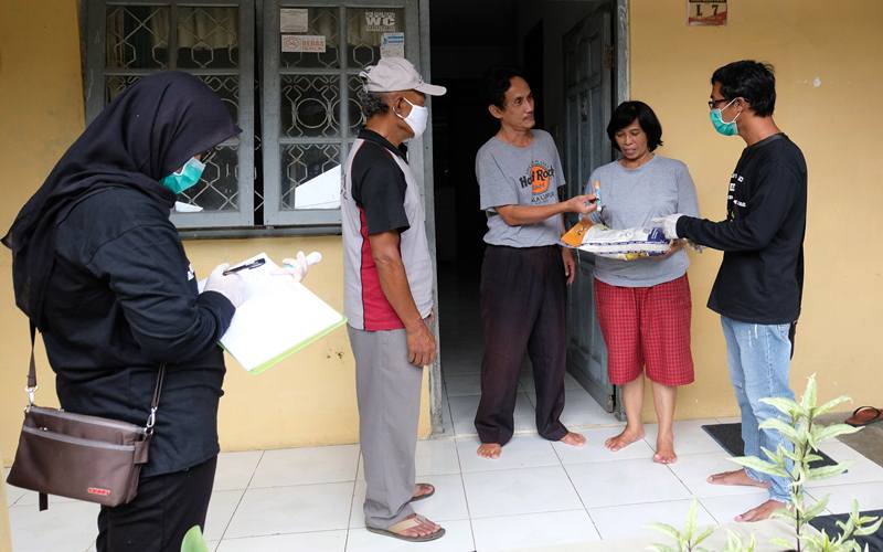 Ilustrasi - Petugas Jaring Pengaman Sosial (JPS) swadaya tingkat desa memberikan bantuan sembako kepada warga terdampak COVID-19 di Perumahan Candi Asri, Kedu, Temanggung, Jawa Tengah, Rabu (8/4/2020). Warga setempat secara swadaya melakukan iuran yang hasilnya disumbangkan kepada warga terdampak COVID-19 berupa sembako dan hand sanitizer. ANTARA FOTO - Anis Efizudin
