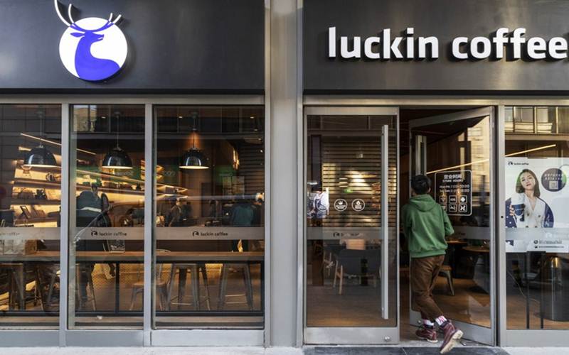 Kustomer memasuki gerai Luckin Coffee di Beijing. - Gilles Sabrie/Bloomberg