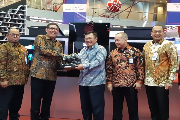 Direktur Utama Bursa Efek Indonesia Inarno Djayadi (kedua dari kiri) memberikan cindera mata kepada Direktur Utama SMF Anata Wiyogo usai pencatatan Penawaran Umum Obligasi Berkelanjutan IV SMF Tahap VIII Tahun 2019, di Gedung Bursa Efek Indonesia, pada Senin (25/3/2019)./Bisnis - Emanuel B.  Caesario