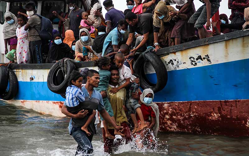 Warga mengevakuasi pengungsi etnis Rohingya dari kapal di pesisir pantai Lancok, Aceh Utara, Aceh, pada Kamis (25/6/2020). - Antara/Rahmad