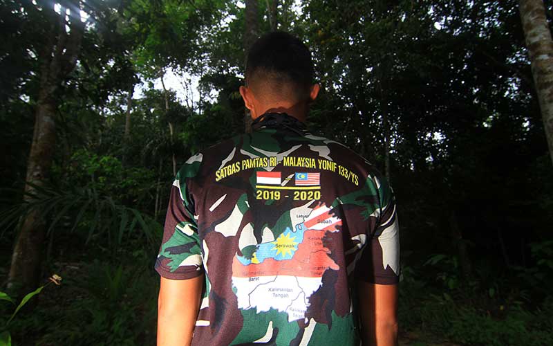 Seorang anggota Satgas Pamtas RI-Malaysia Yonif 133/Yudha Sakti mengenakan baju bergambar peta Pulau Kalimantan. ANTARA FOTO - Jessica Helena Wuysang