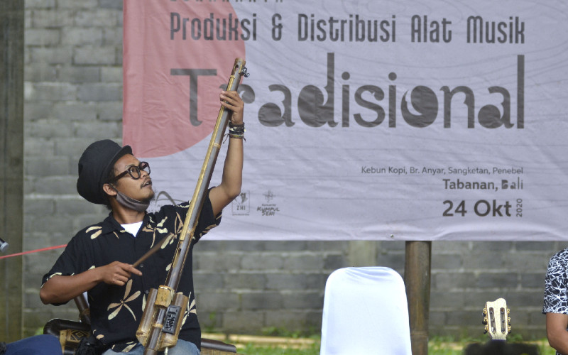 Perajin Rizal Abdulhadi memainkan alat musik tradisional berbahan bambu buatannya saat kegiatan Lokakarya Produksi dan Distribusi Alat Musik Tradisional di kawasan Desa Sangketan, Tabanan, Bali, Sabtu (24/10/2020). Kegiatan tersebut diselenggarakan untuk mengenalkan dan membahas proses produksi hingga distribusi berbagai jenis alat musik tradisional sebagai upaya mendukung pengembangan ekonomi kreatif bagi kreator dan produsen alat musik tradisional.  - ANTARA