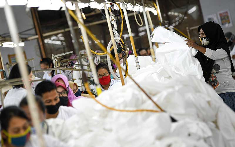 Pekerja perempuan memproduksi alat pelindung diri sebuah perusahaan garmen saat kunjungan Menteri Ketenagakerjaan Ida Fauziyah di Jakarta, Rabu (1/7/2020). Kunjungan Menaker tersebut guna memastikan pekerja perempuan pada sektor industri tidak mendapatkan perlakuan diskriminatif serta untuk mengecek fasilitas laktasi dan perlindungan kesehatan bagi pekerja terutama saat pandemi Covid-19. ANTARA FOTO - M Risyal Hidayat