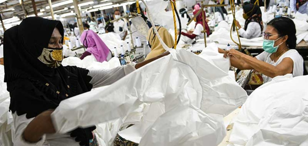 Pekerja perempuan memproduksi alat pelindung diri sebuah perusahaan garmen, Rabu (1/7/2020). Utilitas pabrik terus menunjukkan peningkatan. ANTARA FOTO - M Risyal Hidayat