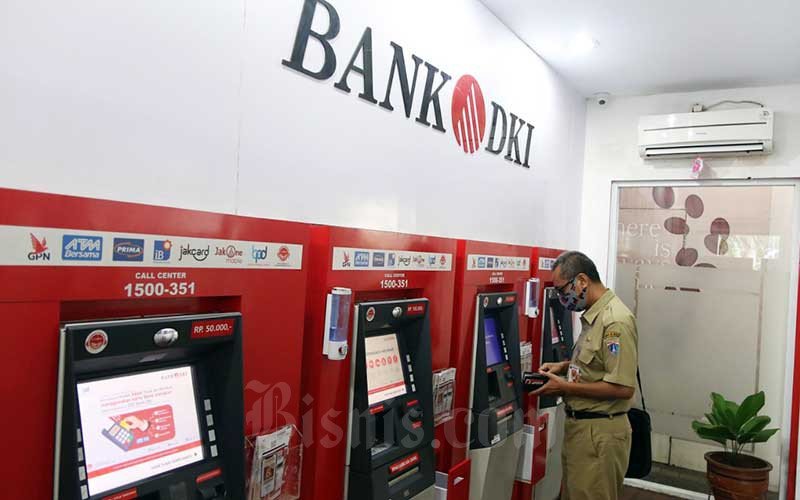 Warga menggunakan fasilitas ATM Bank DKI di Jakarta, Senin (8/6/2020). Bisnis - Eusebio Chrysnamurti