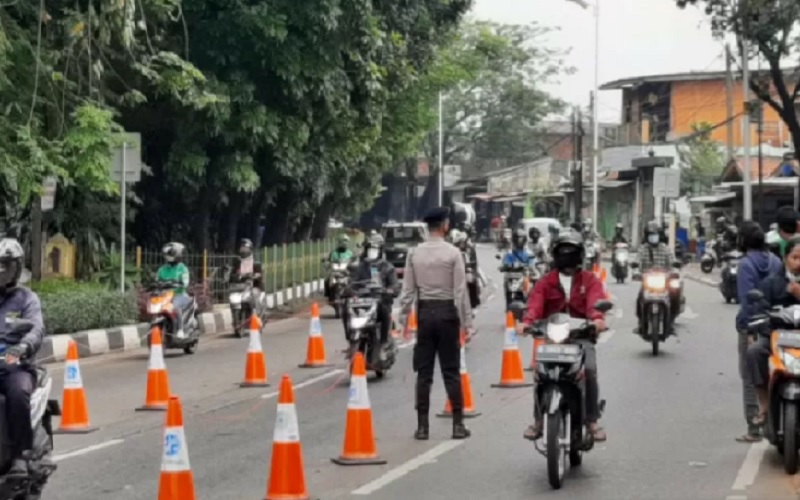 Sejumlah pengendara roda dua melewati petugas di Lenteng Agung Jakarta Selatan, Kamis (22/7/2021). - Antara