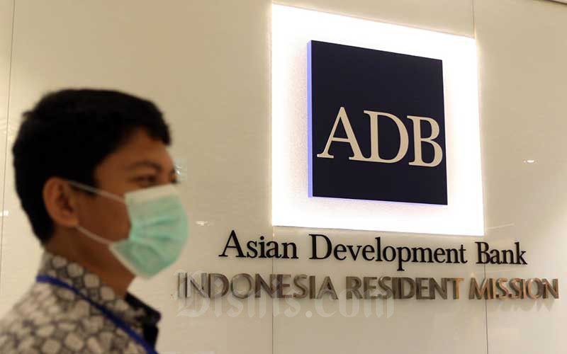 Karyawan berada di dekat logo Asian Development Bank Indonesia di Jakarta, Rabu (8/4/2020). Bisnis - Eusebio Chrysnamurti