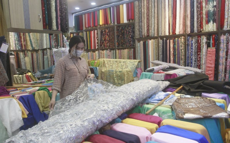 Ilustrasi. Pedagang merapikan kain di salah satu gerai di Pasar Tanah Abang, Jakarta, Selasa (8/12/2020).  - Bisnis.com/Himawan L Nugraha