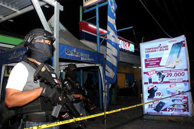 Tim Densus 88 Mabes Polri berjaga saat penggeledahan barang bukti milik terduga teroris, di sebuah kios aksesoris ponsel, Jalan KH Mochtar Tabrani, Bekasi, Jawa Barat, Rabu (8/5/2019). - ANTARA/Risky Andrianto