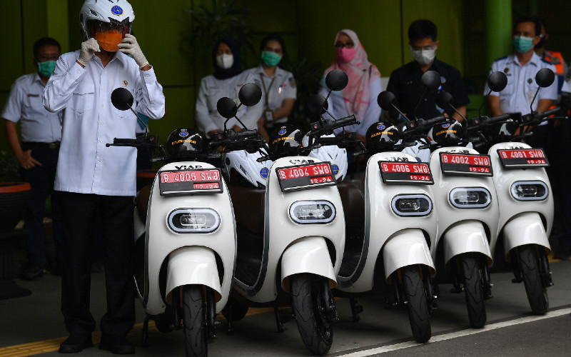 Menteri Perhubungan Budi Karya Sumadi (kiri) bersiap mengendarai motor listrik saat diluncurkan sebagai kendaraan dinas Kementerian Perhubungan di Stasiun Gambir, Jakarta, Rabu (16/12/2020).  - ANTARA FOTO