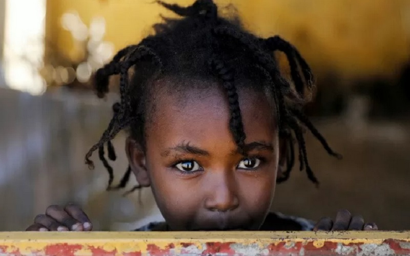 Bocah perempuan berdiri di jendela tempat penampungan sementara, di kamp pengungsian Village 8, menampung pengungsi asal Ethiopia yang menyelamatkan diri dari peperangan di Tigray, dekat perbatasan Sudan-Ethiopia, Sudan, Rabu (2/12/2020). - Antara/Reuters