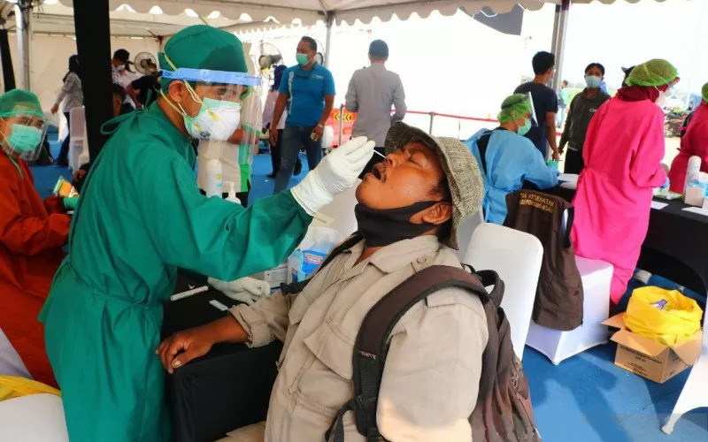 Petugas kesehatan melakukan tes cepat antigen kepada pekerja migran yang tiba di Kepulauan Riau, Selasa (18/5/2021). - Antara/Kemenko PMK