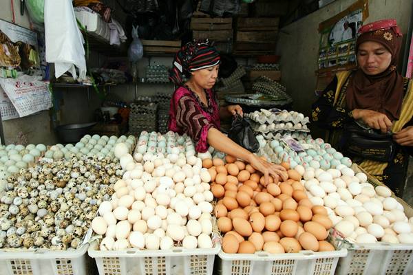 Penjual melayani pembeli telur di pasar Pabean Surabaya, Jawa Timur, Senin (23/5).  - Antara
