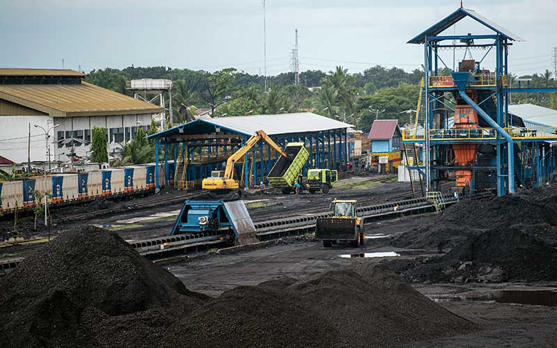 Alat berat merapikan tumpukan batu bara di area pengumpulan Dermaga Batu bara Kertapati milik PT Bukit Asam Tbk di Palembang, Sumatera Selatan, Selasa (4/1/2022). ANTARA FOTO - Nova Wahyudi