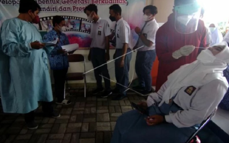 Petugas kesehatan melakukan tes usap antigen kepada siswa di SMAN 5 Tegal, Jawa Tengah, Senin (17/1/2022). - Antara