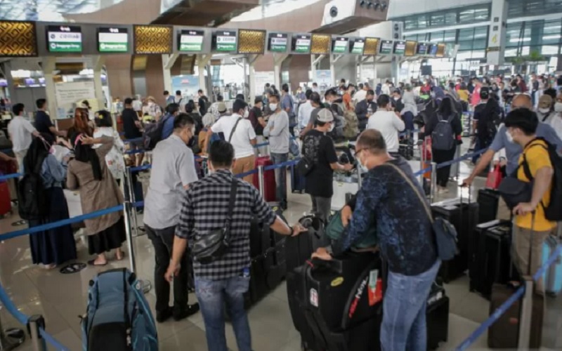 Penumpang pesawat mengantre di loket lapor diri sebelum melakukan penerbangan di area Terminal 3 Bandara Internasional Soekarno Hatta, Tangerang, Banten, Jumat (17/12/2021). - Antara