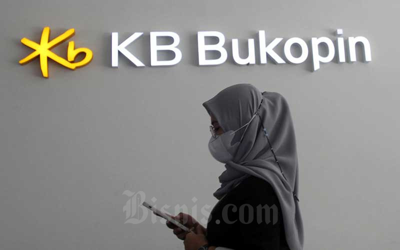 Nasabah melintasi logo Bank KB Bukopin di Makassar, Sulawesi Selatan, Rabu (26/1/2022). Bisnis - Paulus Tandi Bone