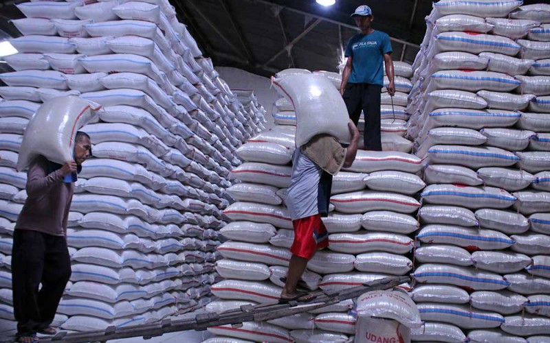 Pekerja memanggul karung berisi beras di Pasar Induk Cipinang, Jakarta, Rabu (21/9/2022). Pemerintah optimis neraca produktivitas pangan terjaga sampai Desember 2022 menyusul sejumlah komoditas mengalami surplus seperti beras yang surplus mencapai 7,5 juta ton. ANTARA FOTO/Henry Purba