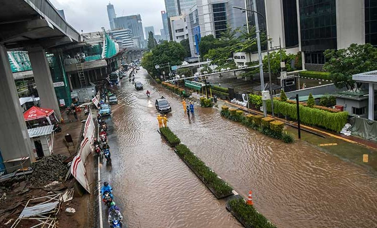 Kendaraan melintasi banjir yang menggenangi di Jalan H. R. Rasuna Said, Kuningan, Jakarta, Selasa (25/2/2020). Hujan deras sejak Senin dini hari membuat sejumlah daerah di Ibu Kota tergenang banjir.  - ANTARA FOTO