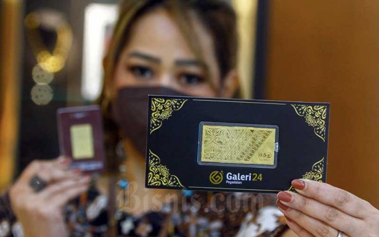 Pegawai menunjukan emas batangan di Galeri 24 Pegadaian, Jakarta, Rabu (5/1/2021).  - Bisnis/Himawan L Nugraha