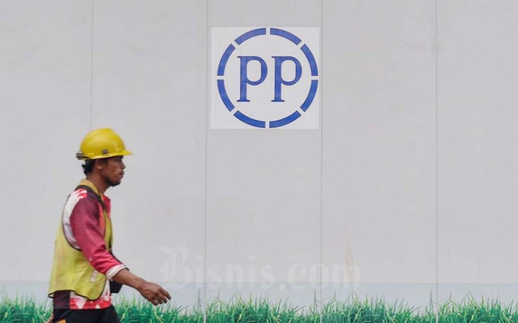 Pekerja melintas di dekat logo PT PP Properti Tbk. (PPRO) di Jakarta, Kamis (20/1/2022). Bisnis - Fanny Kusumawardhani