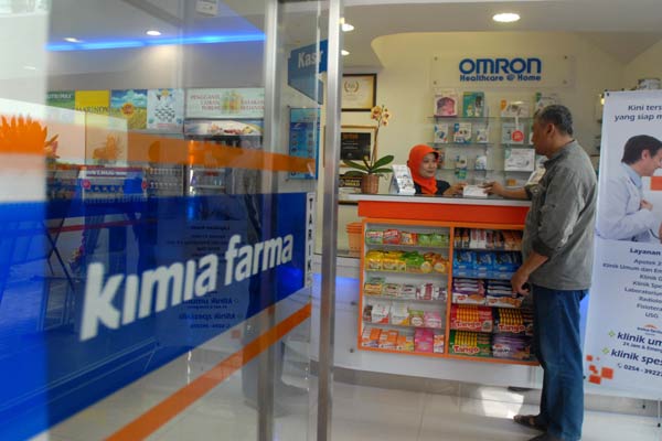 Konsumen melakukan transaksi di salah satu apotek Kimia Farma.  - Bisnis.com