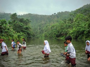 Sejumlah siswa menyeberangi Sungai Ciujung untuk sekolah di Desa Sukaluyu, Cikadu, Cianjur Selatan, Kabupaten Cianjur, Jawa Barat, Rabu (10/8/2022). Sejak tahun 2018, ratusan siswa dari Desa Karyabakti terpaksa harus menerjang Sungai Ciujung untuk sekolah di SDN Padawaras Desa Sukaluyu karena tidak ada akses jalan lain untuk menuju sekolah mereka. ANTARA FOTO/Raisan Al Farisi